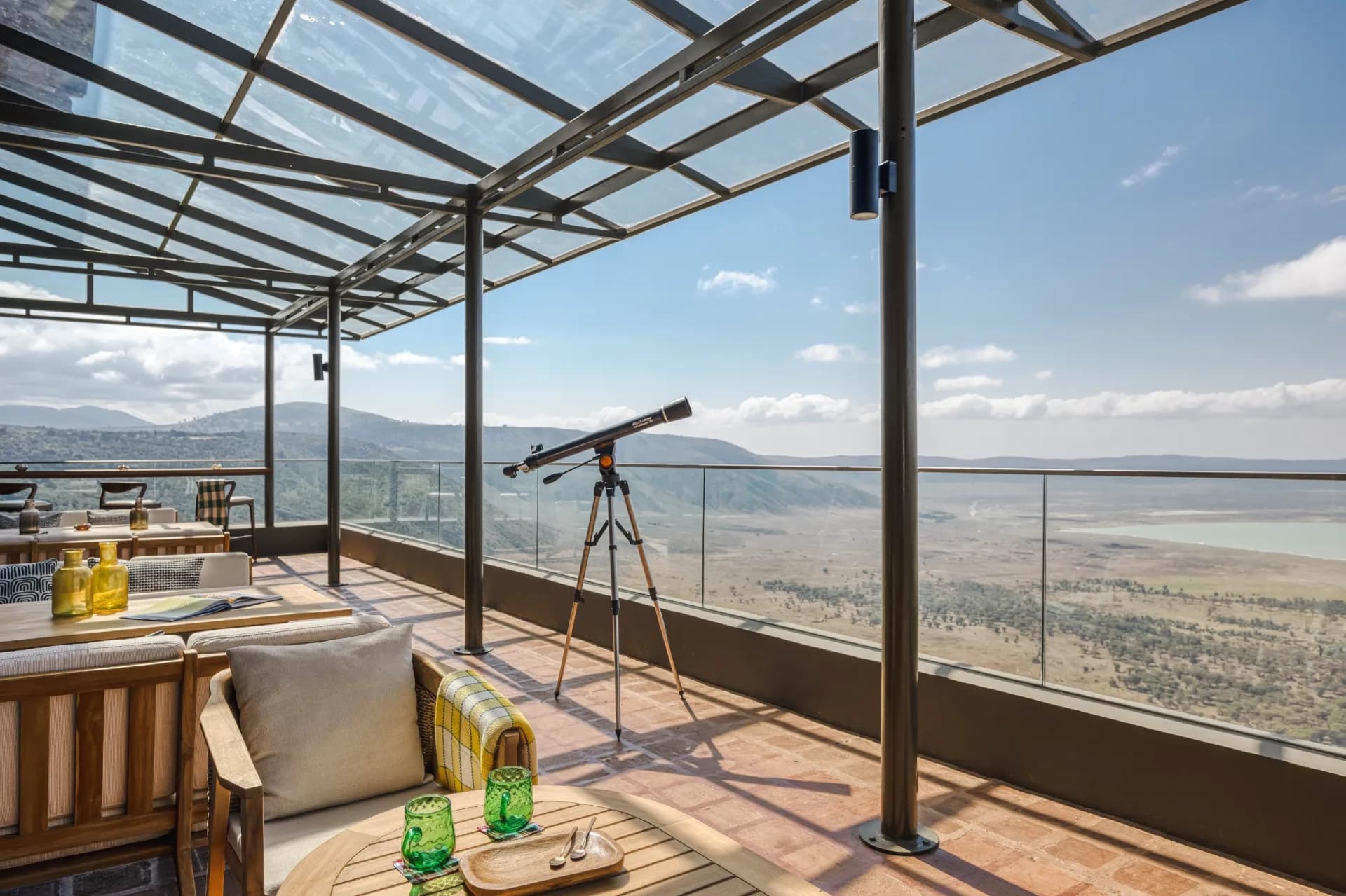 Glass-roofed lounge with a telescope overlooking the Ngorongoro Crater floor at Meliá Ngorongoro