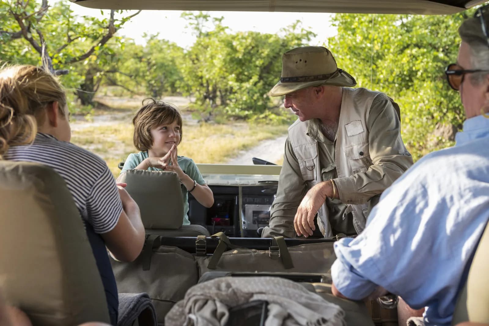 An EXG guide talking with a young traveler during a private safari